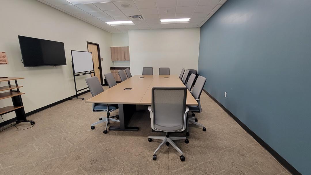 Photo of Conference Room with boardroom style table and chairs.